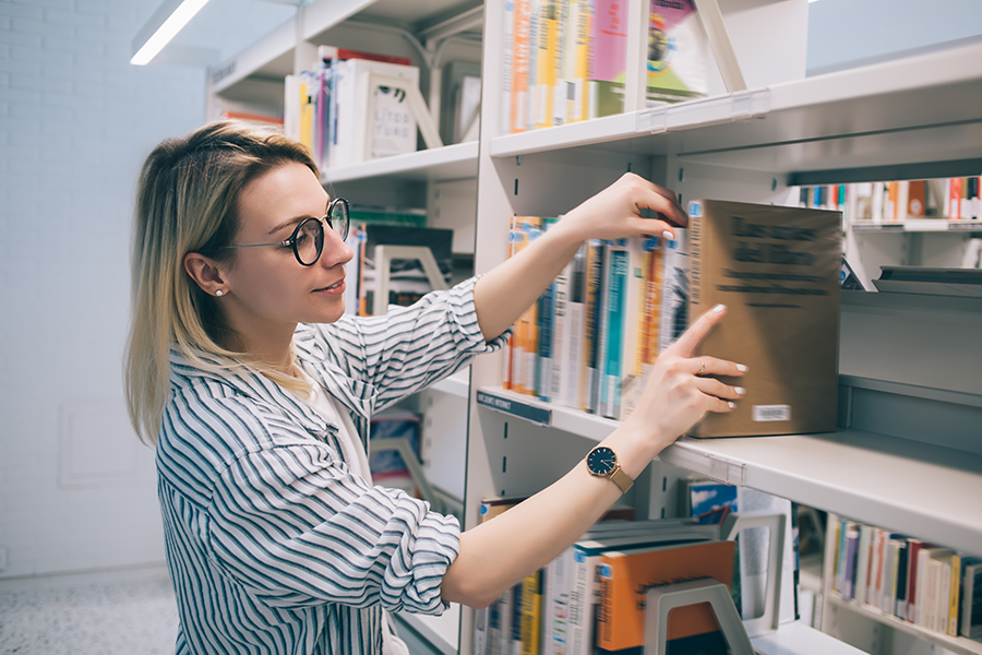 Woman shelving books in the library